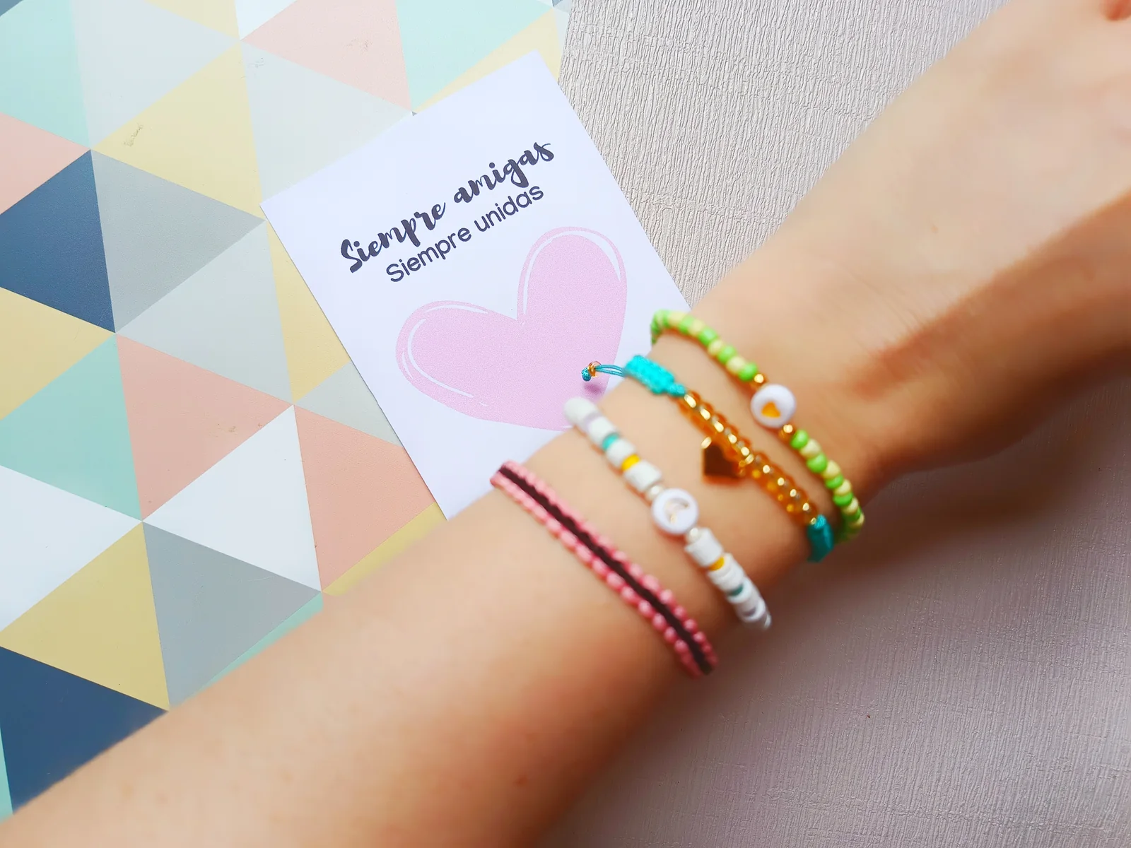 Pulseras y tarjeta mostradas en el material oficial del curso de bisutería creativa